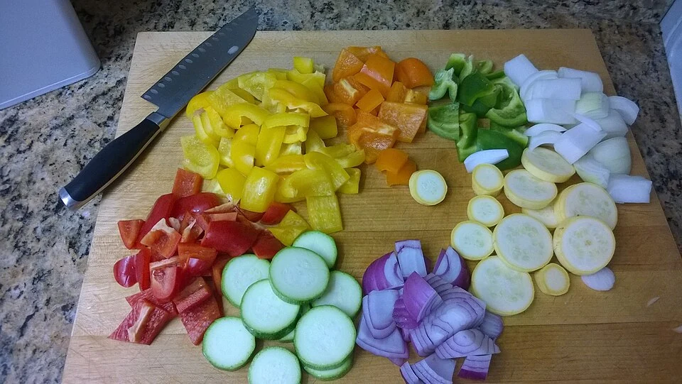Fresh vegetables arranged on a wooden cutting board