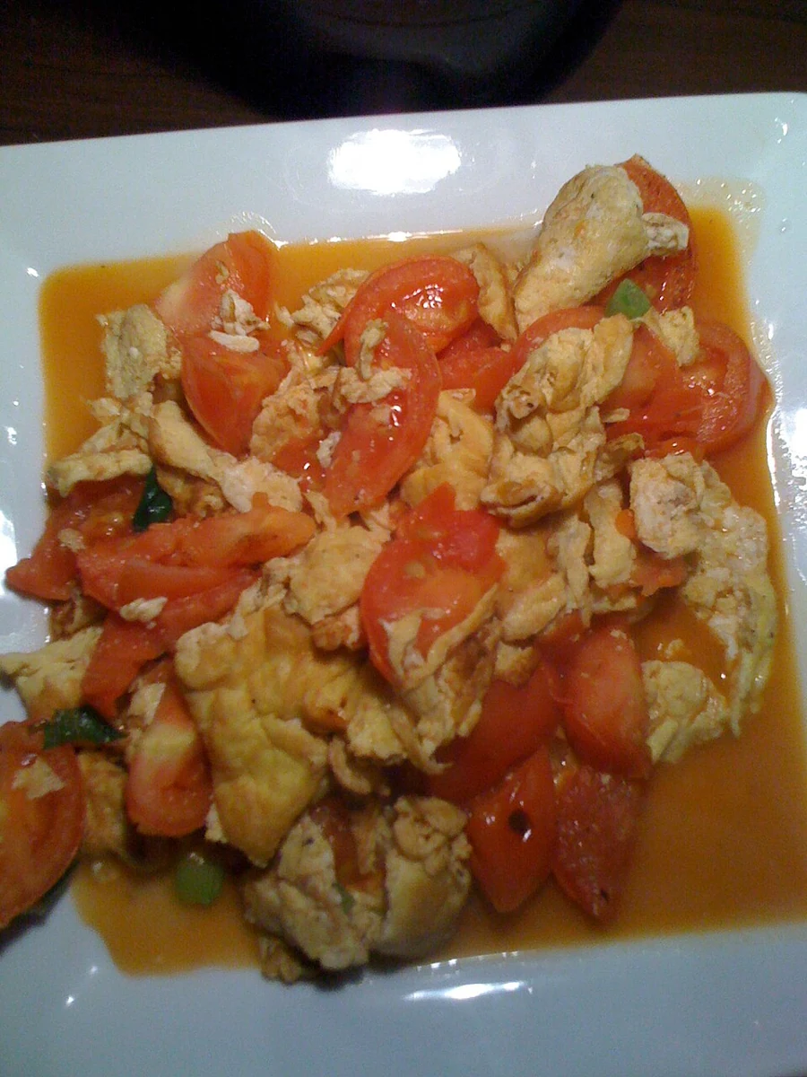 Tomato and egg stir-fry — real photograph